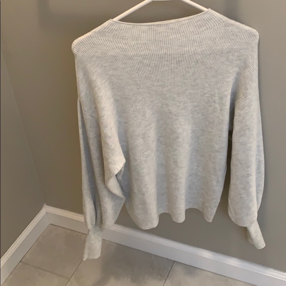 a grey and white blend sweater